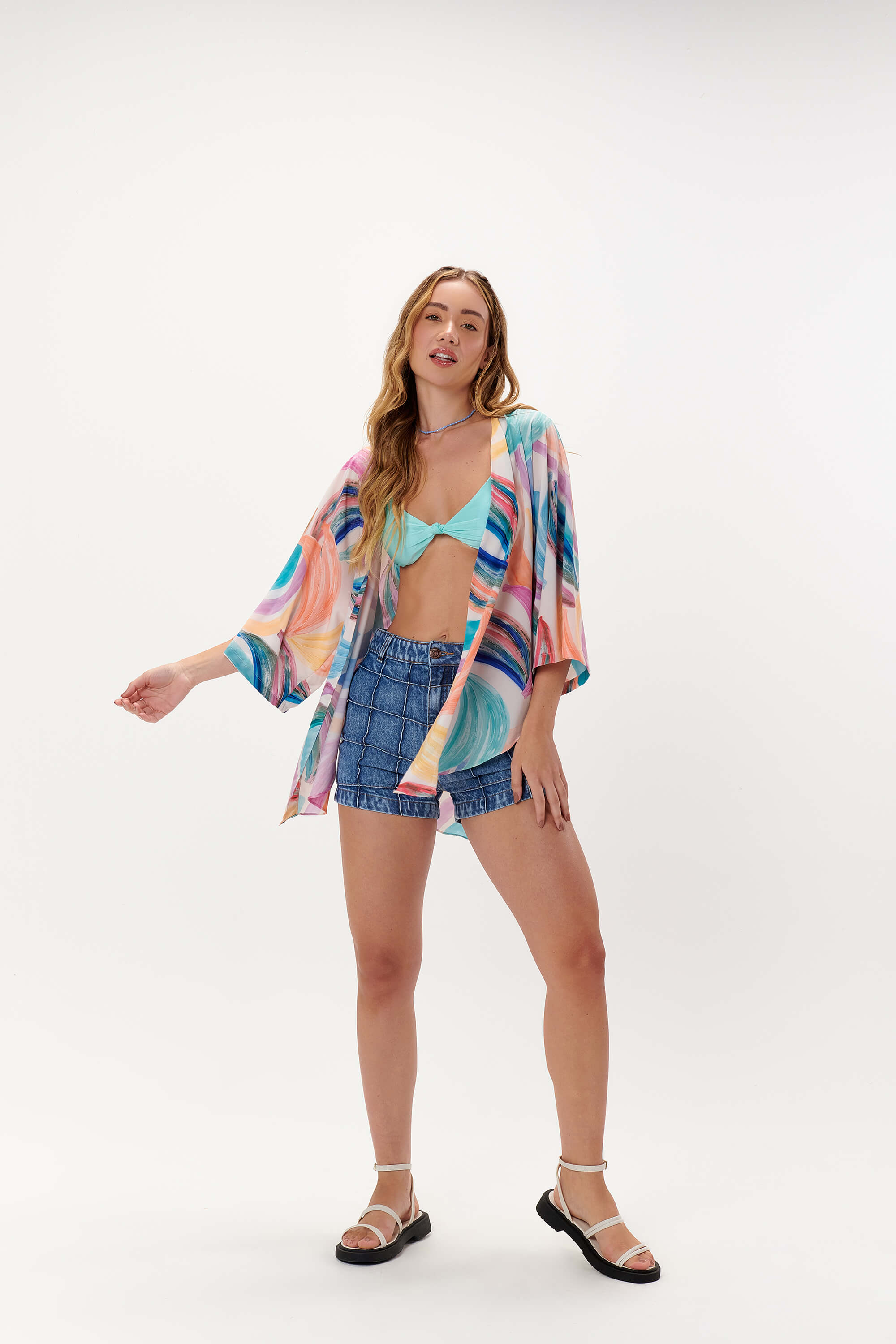 A stylish Oceana Blue bikini swimwear set paired with Isabella denim jean shorts and a Banana Beach kimono, part of DESIRE DENIM’s women’s tropical summer apparel collection.